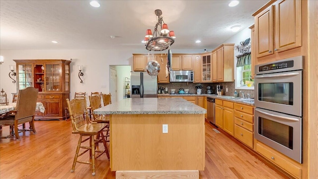 169 Roberts Rd, Starlight, PA 18461 - kitchen featuring stainless steel appliances, a center island, a chandelier, backsplash, and recessed lighting