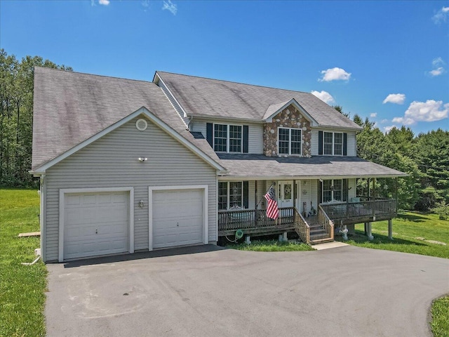 169 Roberts Rd, Starlight, PA 18461 - view of front of property with covered porch, a garage, asphalt driveway, a front yard, and roof with shingles