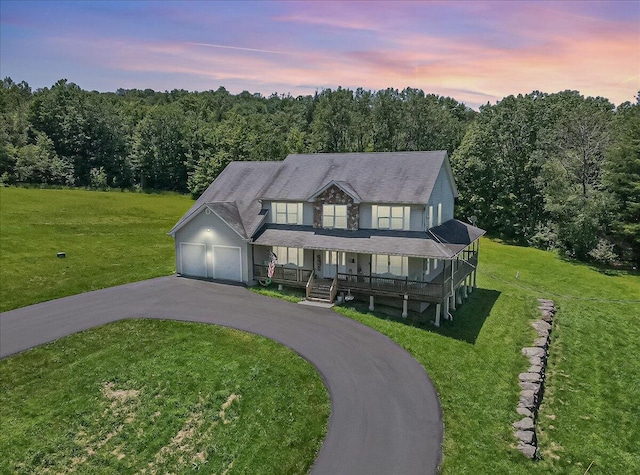 169 Roberts Rd, Starlight, PA 18461 - view of front of property featuring a porch, asphalt driveway, a front yard, and a garage