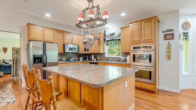 169 Roberts Rd, Starlight, PA 18461 - kitchen featuring stainless steel appliances, light wood finished floors, a kitchen island, decorative backsplash, and recessed lighting