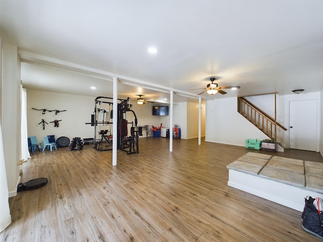 exercise area featuring recessed lighting, ceiling fan, baseboards, and wood finished floors