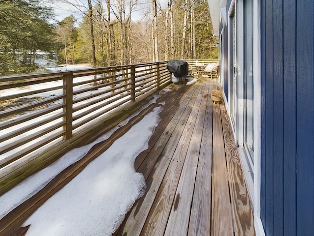 wooden terrace with a grill