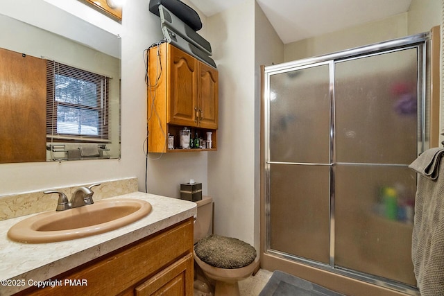 bathroom with toilet, an enclosed shower, and vanity