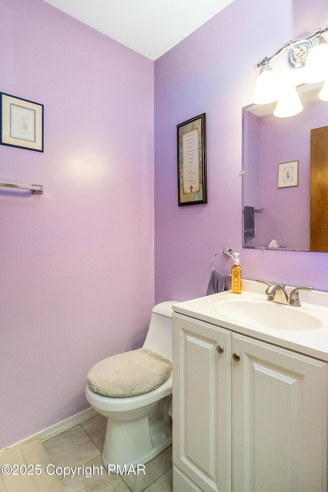 bathroom featuring toilet, vanity, and tile patterned flooring