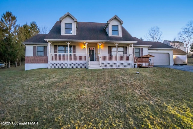 cape cod home with a garage, driveway, a porch, and a front lawn