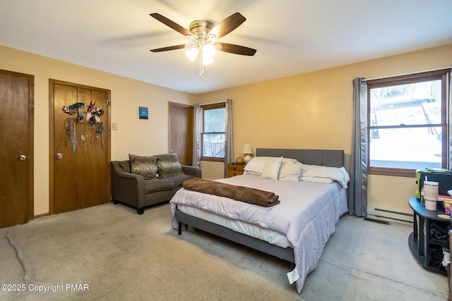 bedroom featuring multiple windows, carpet flooring, ceiling fan, and baseboard heating