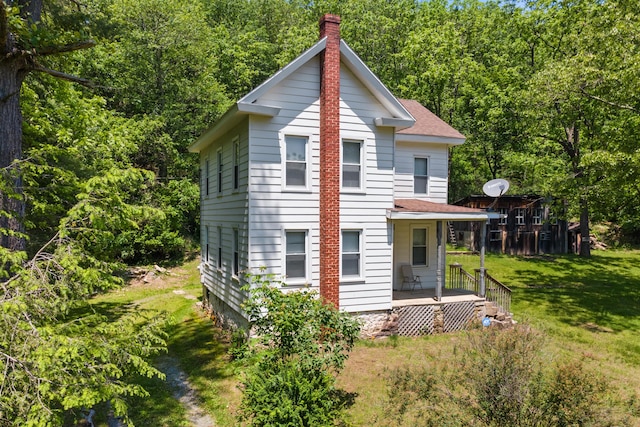 266 Laurel Rd, Lehighton, PA 18235 - back of house featuring a chimney, a lawn, a shingled roof, and a view of trees