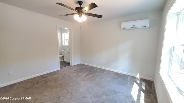 carpeted empty room featuring ceiling fan, baseboards, and a wall mounted AC