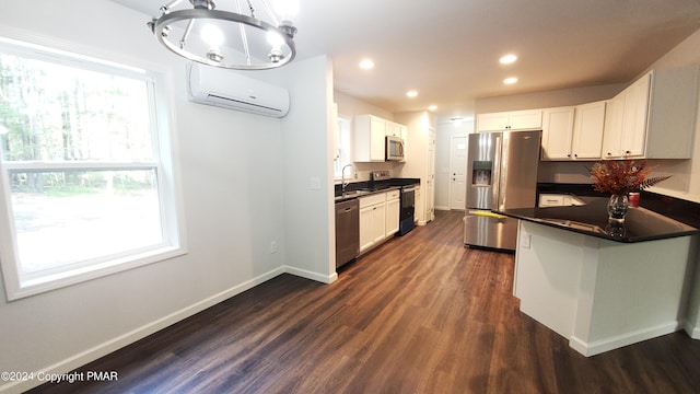 kitchen with appliances with stainless steel finishes, a wall mounted AC, dark countertops, and a sink