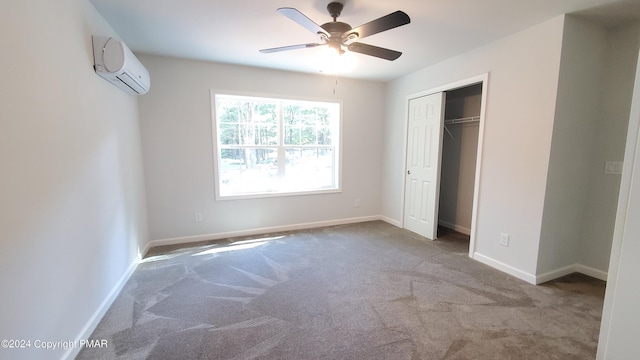 unfurnished bedroom featuring baseboards, ceiling fan, carpet, an AC wall unit, and a closet