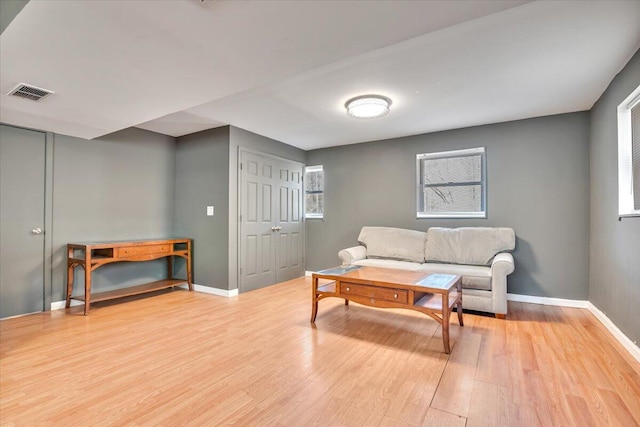 sitting room featuring light wood-type flooring and baseboards