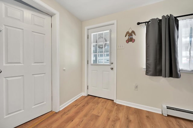 24 W Garibaldi Ave, Nesquehoning, PA 18240 - entryway with baseboards, light wood-style flooring, and a baseboard radiator