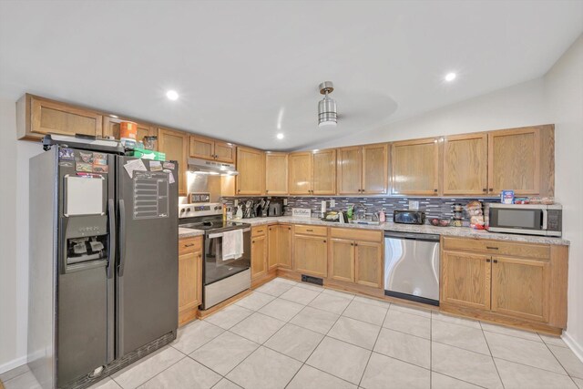 24 W Garibaldi Ave, Nesquehoning, PA 18240 - kitchen with appliances with stainless steel finishes, recessed lighting, decorative backsplash, lofted ceiling, and under cabinet range hood