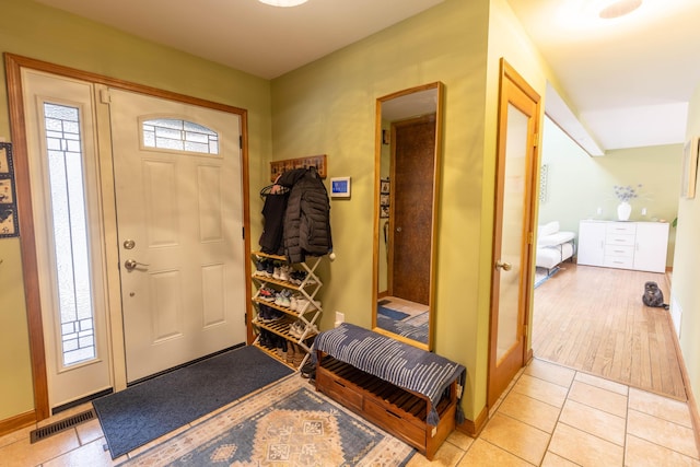 entrance foyer with light tile patterned floors and visible vents