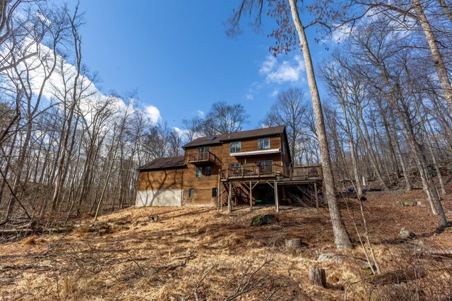 rear view of house with stairway and a wooden deck