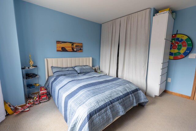 bedroom featuring carpet and baseboards