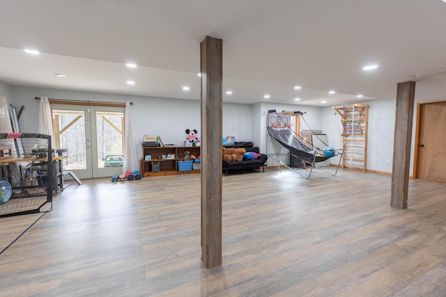 basement with baseboards, french doors, wood finished floors, and recessed lighting