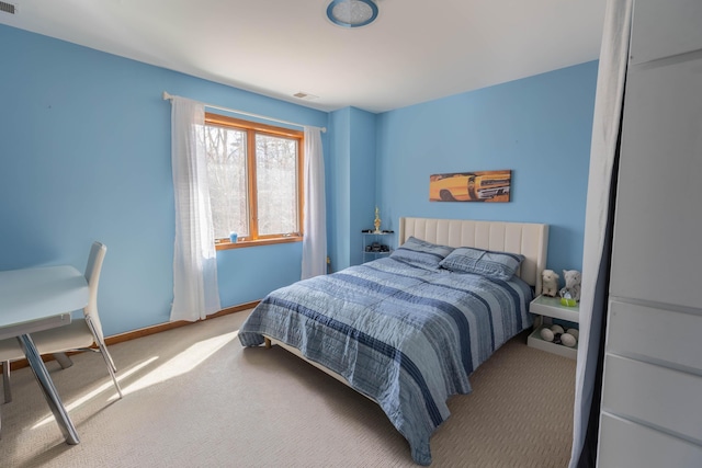 carpeted bedroom with visible vents and baseboards