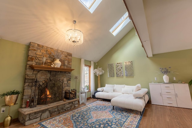 living room featuring a skylight, a fireplace, high vaulted ceiling, and wood finished floors