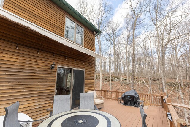 deck featuring grilling area and outdoor dining area