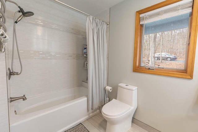 bathroom with toilet and shower / tub combo with curtain