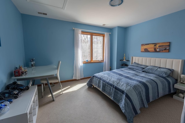 bedroom with light carpet, attic access, visible vents, and baseboards