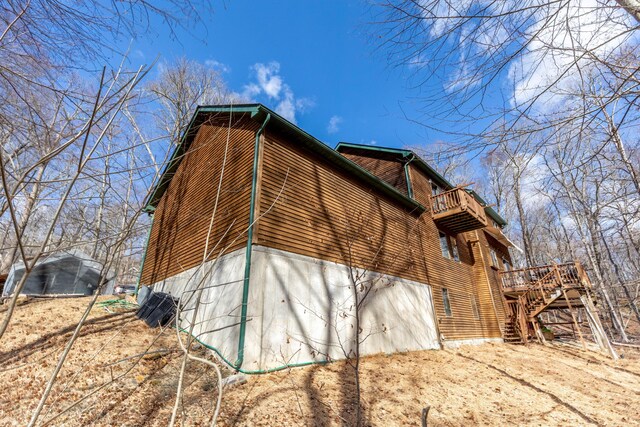 view of side of home featuring stairs