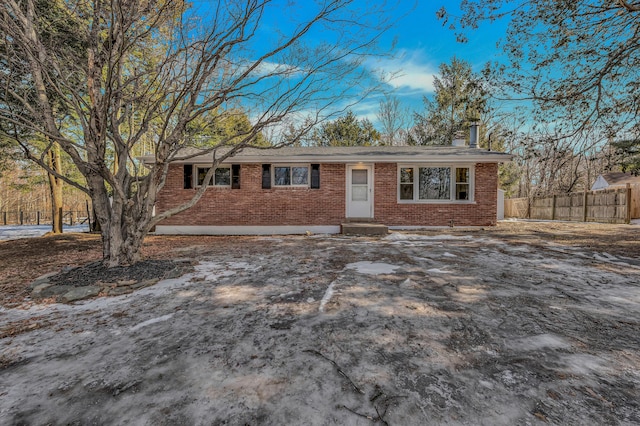 ranch-style house with fence and brick siding