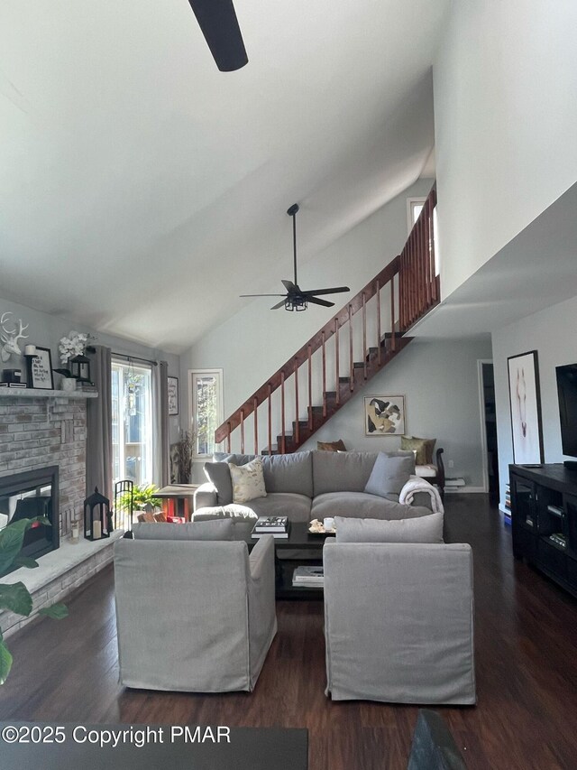 living room featuring dark hardwood / wood-style flooring, high vaulted ceiling, and ceiling fan