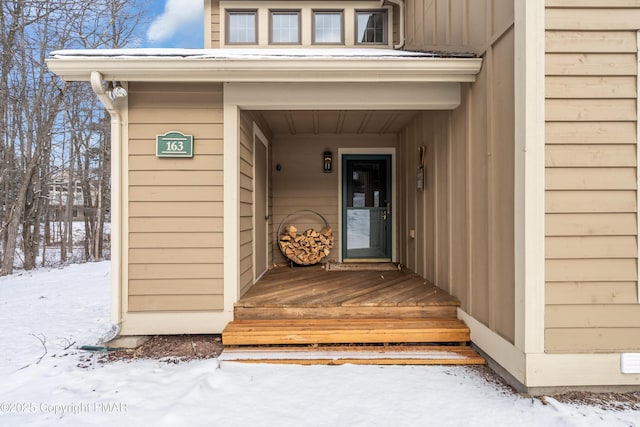 view of snow covered property entrance