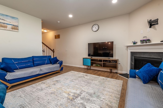 320 Bendelow Ln, Northampton, PA 18067 - living room featuring wood finished floors, a fireplace with flush hearth, recessed lighting, and stairs