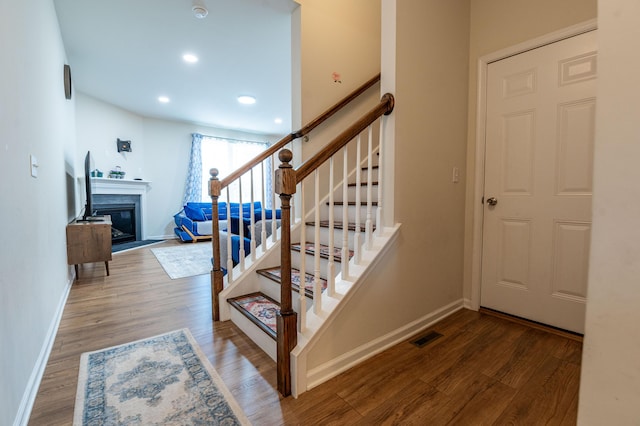 320 Bendelow Ln, Northampton, PA 18067 - stairs with wood finished floors, a glass covered fireplace, and recessed lighting