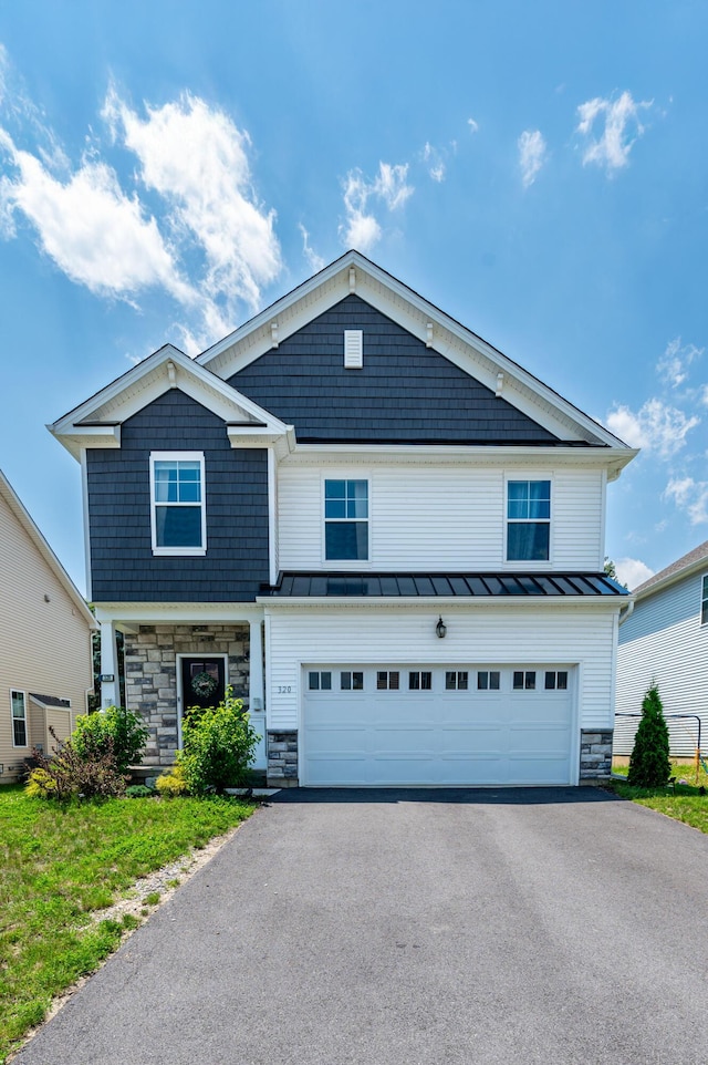 320 Bendelow Ln, Northampton, PA 18067 - view of front of property featuring stone siding, a standing seam roof, asphalt driveway, and an attached garage