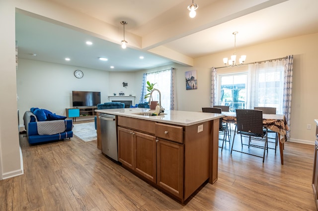 320 Bendelow Ln, Northampton, PA 18067 - kitchen featuring stainless steel dishwasher, brown cabinets, wood finished floors, a fireplace, and open floor plan
