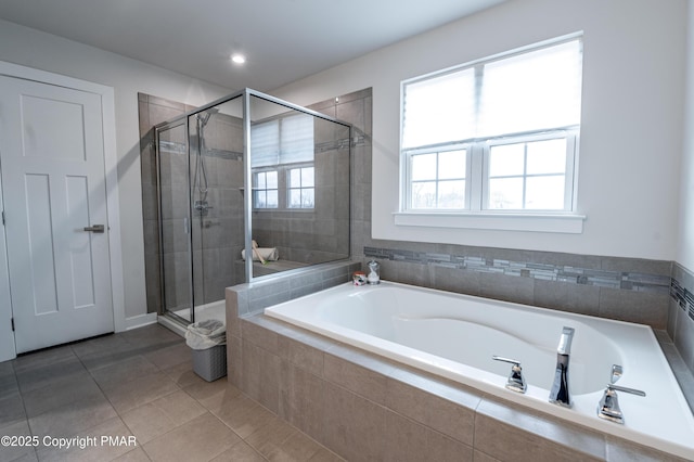 bathroom featuring tile patterned flooring and separate shower and tub