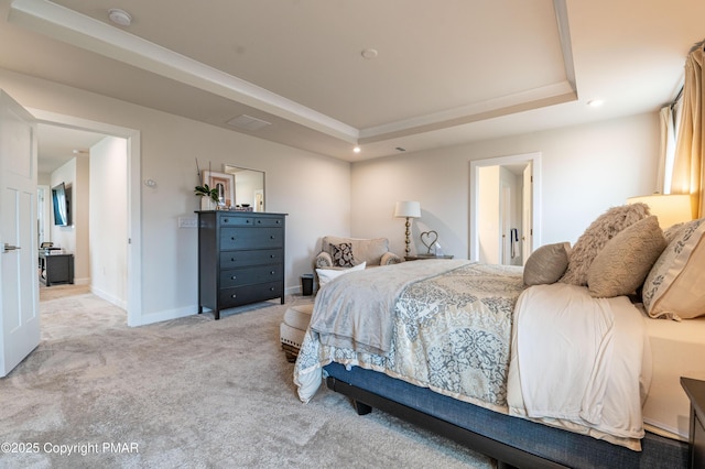 bedroom with a raised ceiling and light carpet