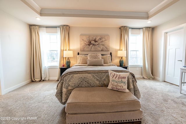 carpeted bedroom featuring a raised ceiling, ornamental molding, and multiple windows