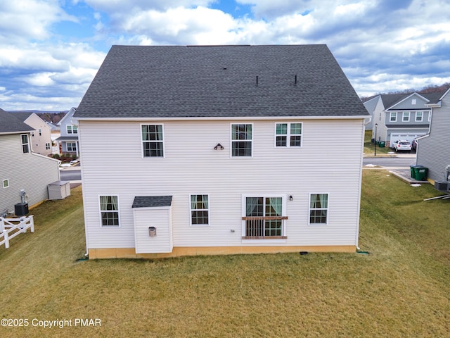 rear view of house with a lawn