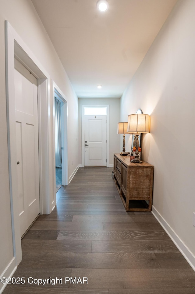 hall with dark wood-type flooring, recessed lighting, and baseboards