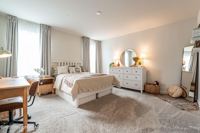 carpeted bedroom featuring multiple windows