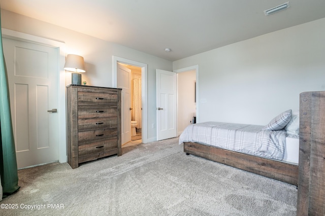 carpeted bedroom featuring connected bathroom