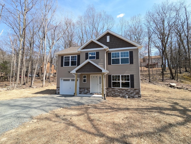 247 Sandlewood Dr, East Stroudsburg, PA 18301 - craftsman-style house with an attached garage, stone siding, and gravel driveway