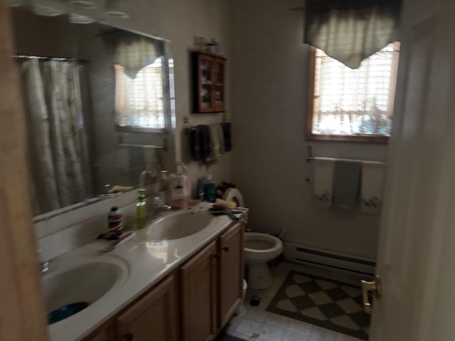 full bath featuring toilet, plenty of natural light, baseboard heating, and a sink