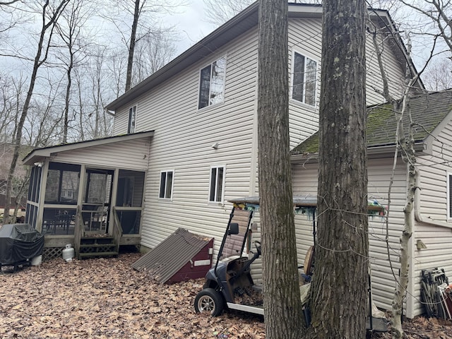 rear view of property with a sunroom