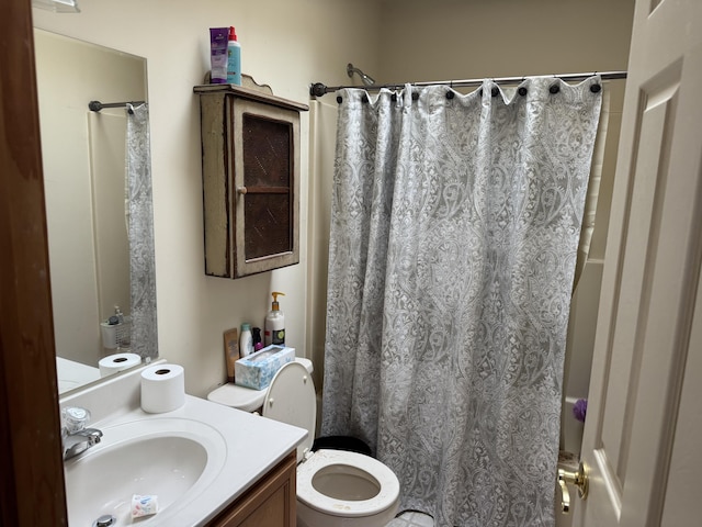 full bathroom with vanity, a shower with shower curtain, and toilet