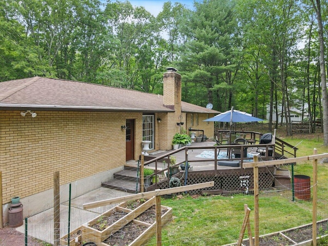 3106 Janet St, East Stroudsburg, PA 18301 - back of house featuring a shingled roof, brick siding, a chimney, and a yard
