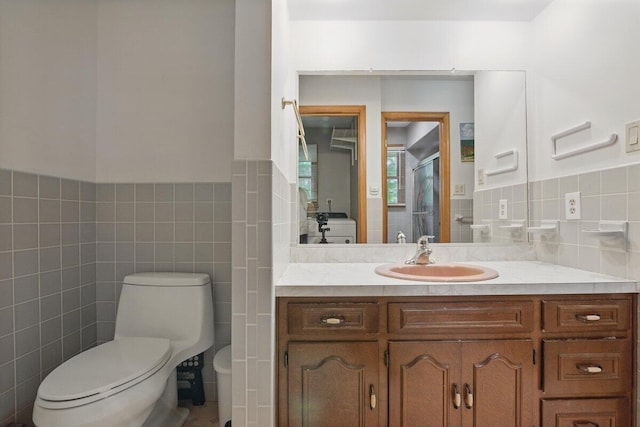 3106 Janet St, East Stroudsburg, PA 18301 - bathroom with tile walls, toilet, vanity, a stall shower, and wainscoting