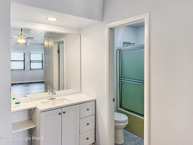full bathroom featuring a ceiling fan, toilet, shower / bath combination with glass door, tile patterned floors, and vanity