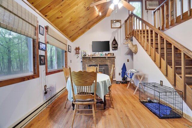 235 Scenic Dr, East Stroudsburg, PA 18302 - dining area with a baseboard heating unit, a ceiling fan, plenty of natural light, wood finished floors, and high vaulted ceiling