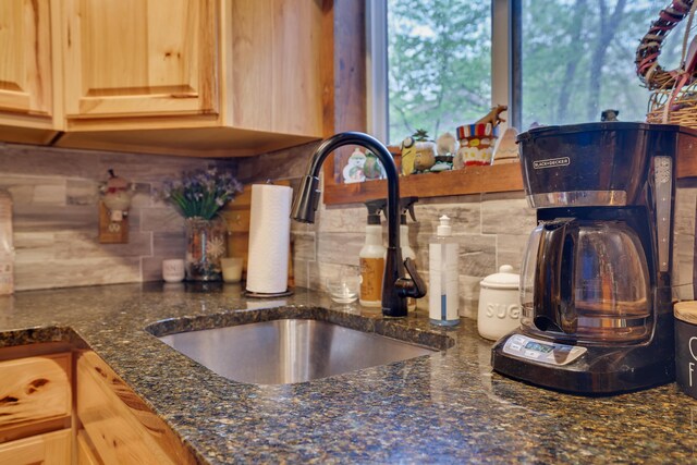 235 Scenic Dr, East Stroudsburg, PA 18302 - kitchen view of a sink, backsplash, light brown cabinets, and dark stone countertops
